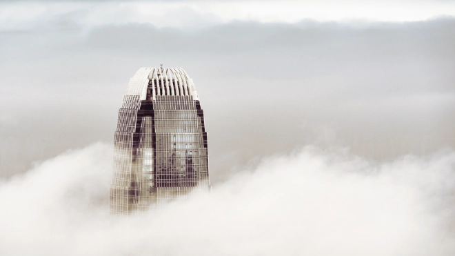 Skyscrapper building peaking through the clouds