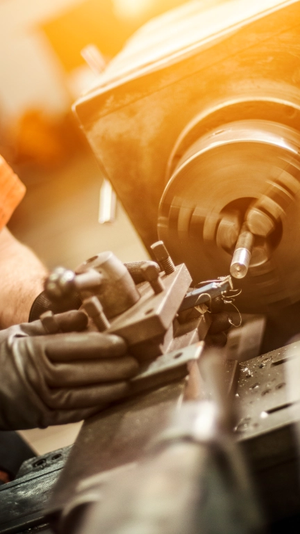 Male engineer drilling machine parts