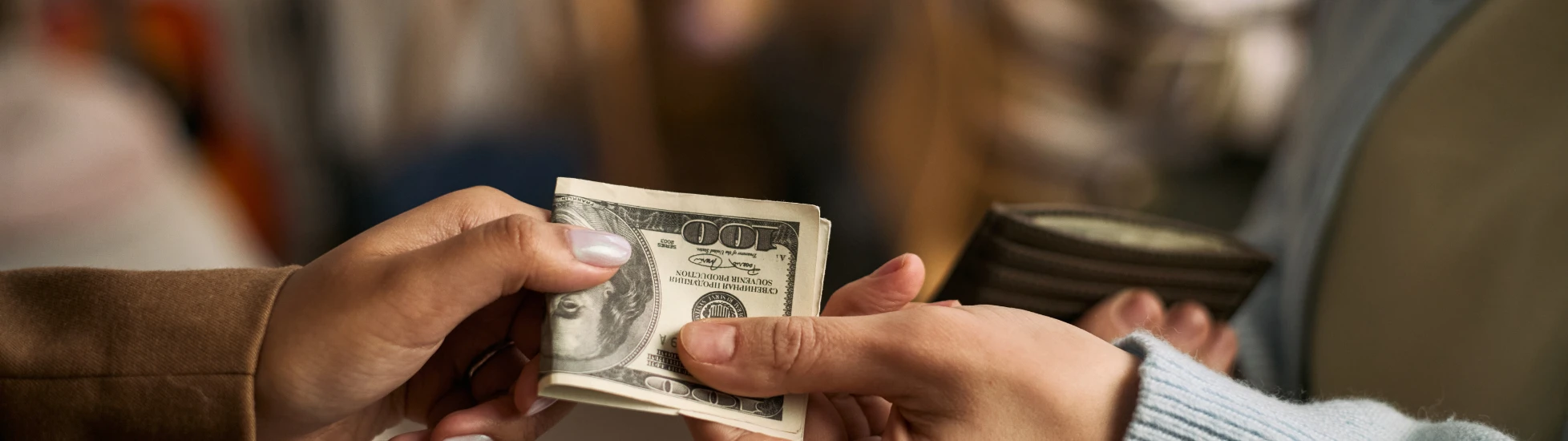 customer handing over cash to business owner