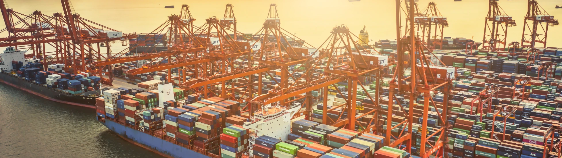 Aerial view of large ship in dock with containers