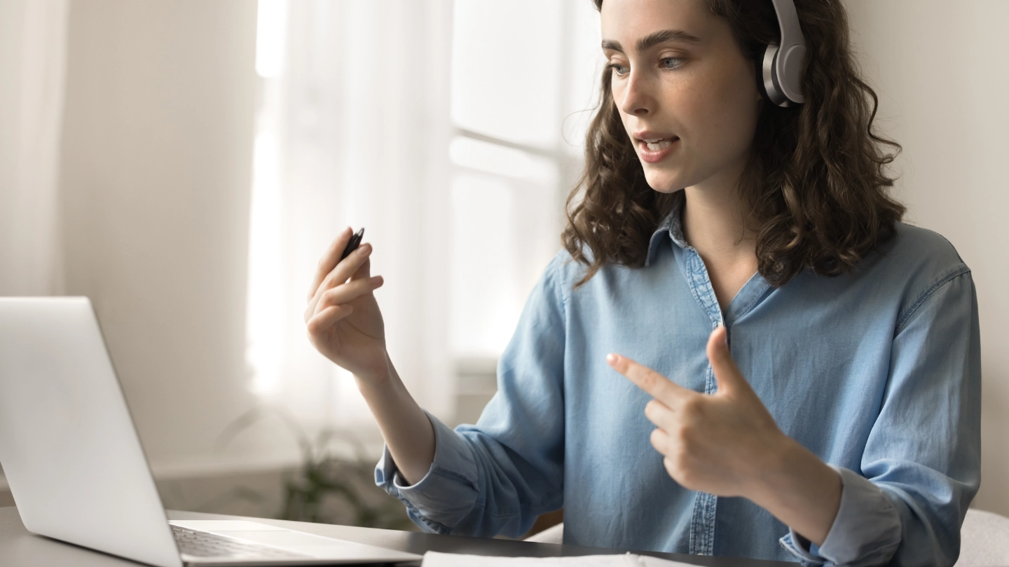 woman at laptop with a headset image