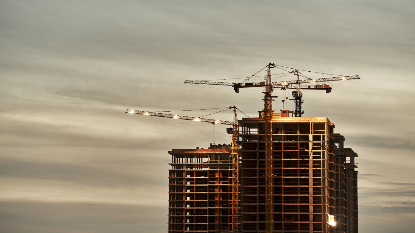 Construction site with crane at dusk