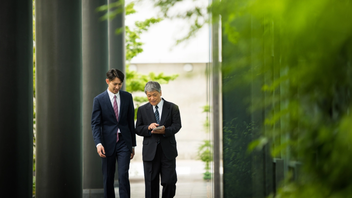Colleagues strolling in greenery