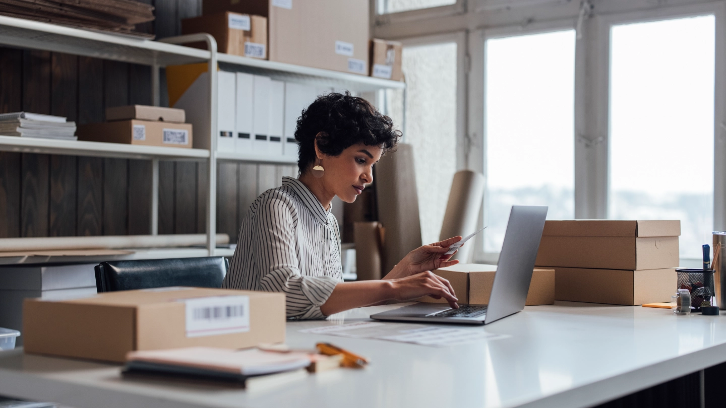 Woman in office surrounded by boxes image