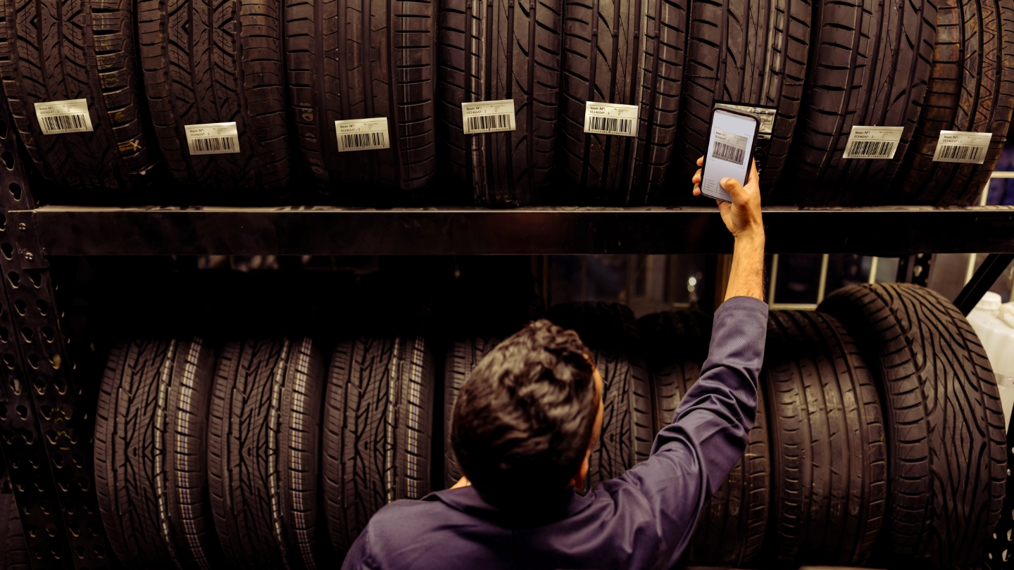 Automotive worker checking tyres