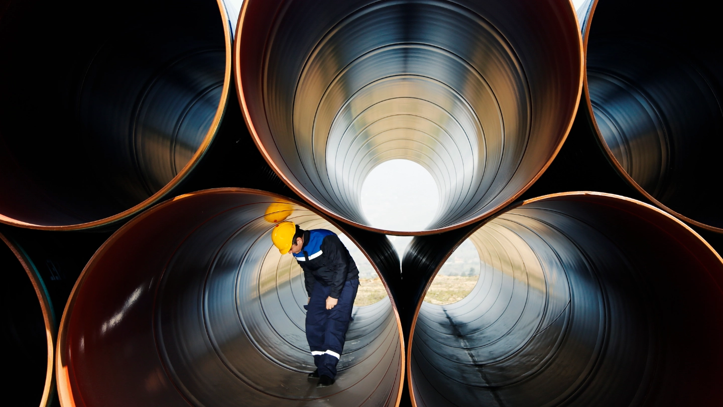 Worker inside industrial pipes image