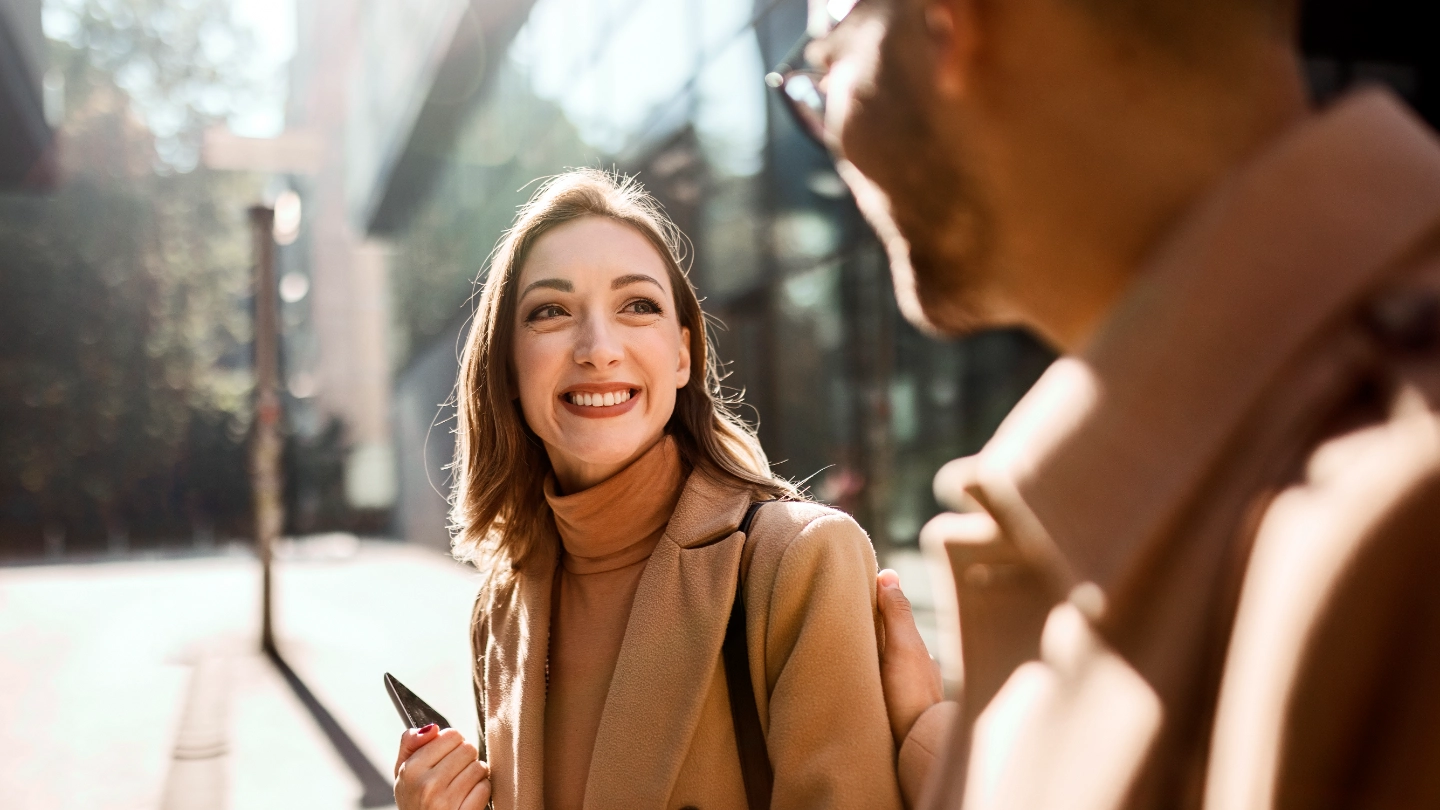 young woman smiling at man