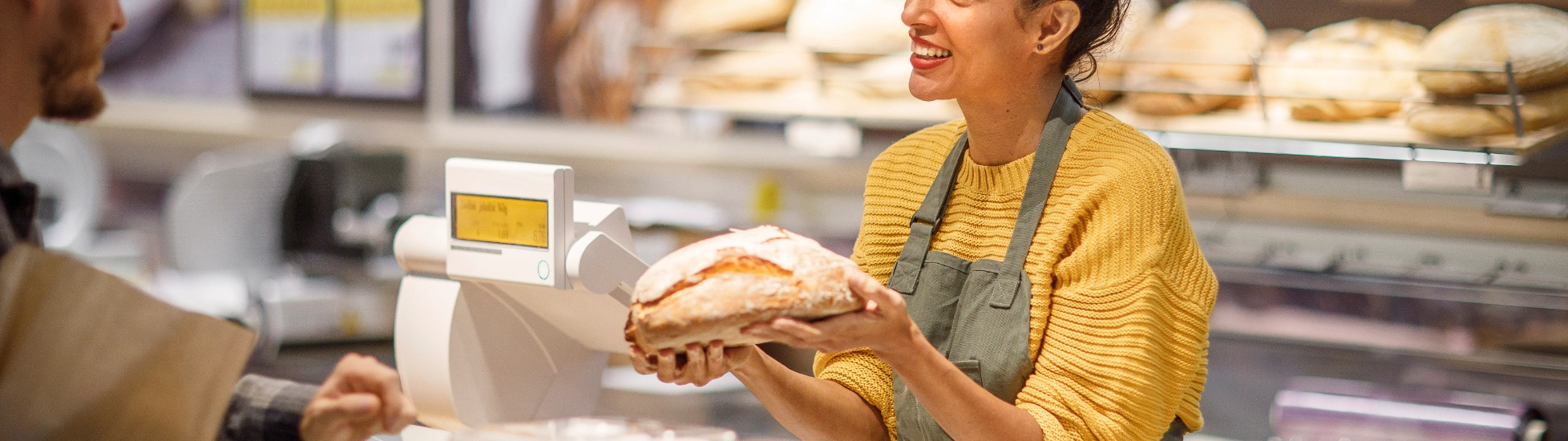 Woman selling bread at a bakery